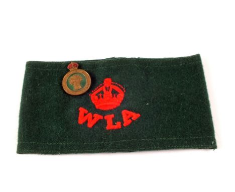 A WWII era woman's Land Army armband and lapel hat badge