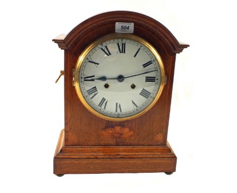 An inlaid Oak striking bracket clock