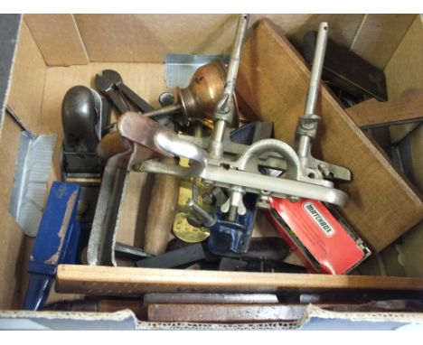 Various woodworking tools including thumb and plough planes