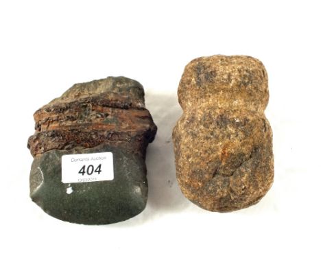 Two early stone axe heads, one American