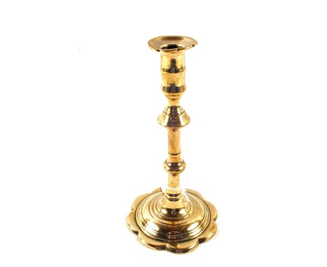 An 18th Century petal based Brass candlestick with knopped stem, height 8 1/2"
