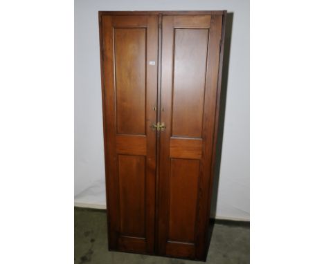Edwardian pine double door cupboard enclosed by two panelled doors with coat hanging racks and shelves to the interior (84cm 