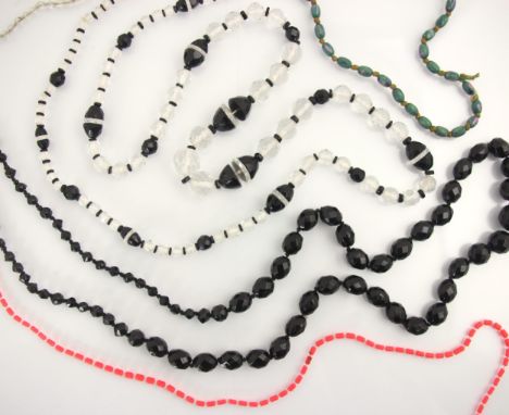 A selection of beads, including an Art Deco style faceted paste example with onyx coloured spacers, a faceted onyx coloured e