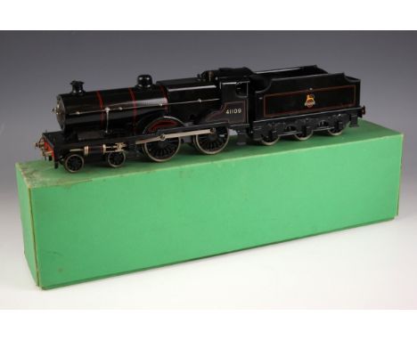 An 'O' gauge electrically powered model railway locomotive and tender numbered '41109' in black British Railways livery, the 