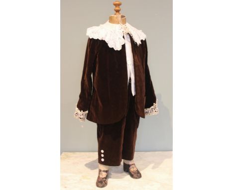 A late Victorian childs assembled costume of brown velvet, with lace collar and cuffs, the trousers with mother of pearl butt