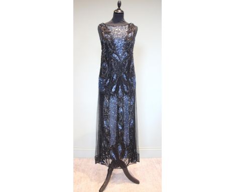 A 1920's black tulle evening dress, copiously beaded with black bugle beads and blue sequins in an all over stylised pattern,