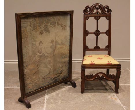 A 19th century oak low seat side chair, with a carved scroll crest over a lunette and flowerhead rail back, upholstered seat 