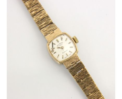 A 9ct yellow gold ladies Rotary wristwatch, the silvered square dial with baton markers, set to plain polished case with inte