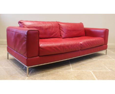 An Italian style contemporary red leather sofa, of angular deep set form, with fixed rear cushions, upon a brushed metal tubu