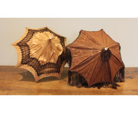 A mid Victorian pagoda parasol, with brown silk mount applied with black bobbin lace trim, lined with ivory silk with metal r