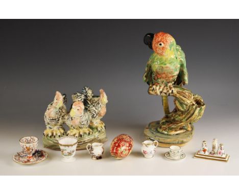 A studio pottery study of a parrot, naturalistically modelled sitting on a tree branch, unmarked, 34.5cm high, with a studio 