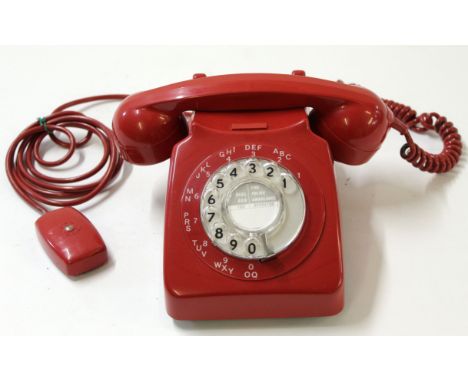 Vintage red GPO plastic telephone with rotary dial, stamped "746F.DFM" and 69/1 underneath 