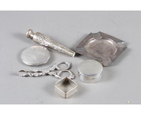 A pair of Victorian cast silver sugar nips, decorated foliage, a silver pill box, a silver napkin ring, an ashtray, a compact