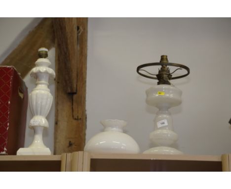 An assortment of light fittings, including a brass oil lamp, ceiling lights and a white glass oil lamp, fitted as a table lam