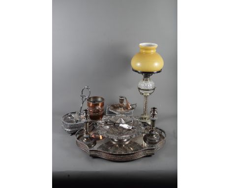 A silver plated oval two-handled tea tray, 21" wide, a pair of plated candlesticks, an oil lamp, on plated stand and other pl