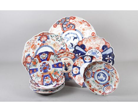 Three Imari shaped dishes, 12", 13" and 14" dia, and seven Imari decorated plates, 8" dia (damages) 