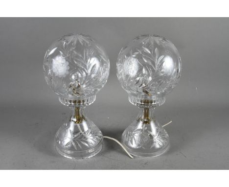 A pair of cut glass globe table lamps, on circular bases, 14" high 