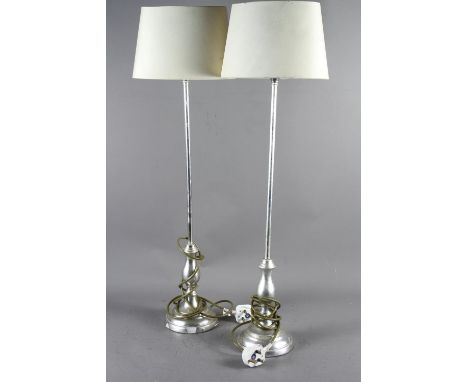 A pair of silvered table lamps, on circular bases, with oval shades, 33" high 