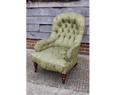 A 19th century tub-shape armchair, button upholstered in a green floral brocade, on turned and castored supports, a Georgian 