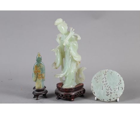 A Chinese jade carving of Kuan-Yin, on wooden base, 8 1/2" high, a smaller jade carving of an immortal, on wooden base, 5" hi