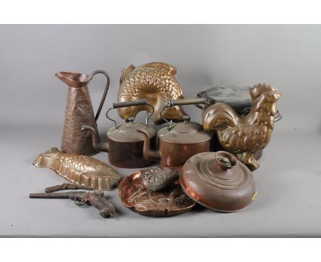 Two copper coffee pots, a shaped copper tray with embossed ship at sea decoration, two copper jelly moulds, formed as fish, o