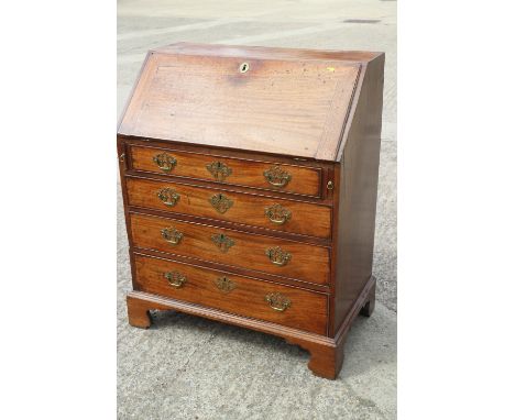 A Georgian mahogany fall front bureau with fitted interior, over four long graduated drawers with pierced brass handles, on b