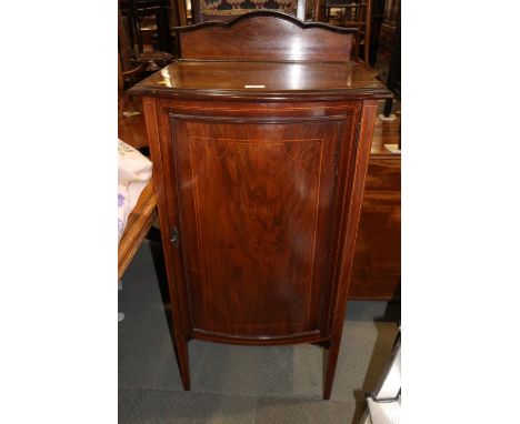 An Edwardian mahogany and line inlaid music cabinet with ledge back and cupboard door enclosed three shelves, on square taper