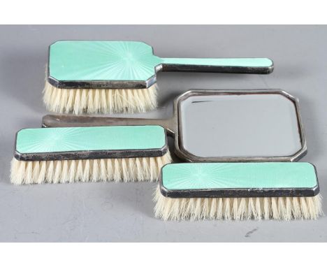 A pair of mid 20th century silver and green enamel clothes brushes, a matching hairbrush and hand mirrorCondition:Some losses