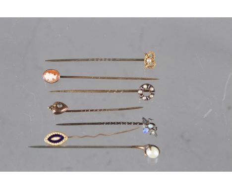 A silver stick pin, decorated with an opal set bug, one set agate and split pearls, and five others 