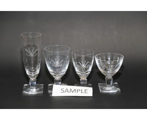 A quantity of clear table glass with engraved decoration, on square bases