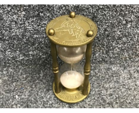 Vintage brass hourglass sand timer depicting time