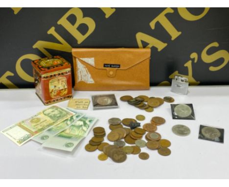 Vintage Tin containing misc coinage and Ronson lighter, also includes a wallet containing Bank notes (includes 2x £1 notes)