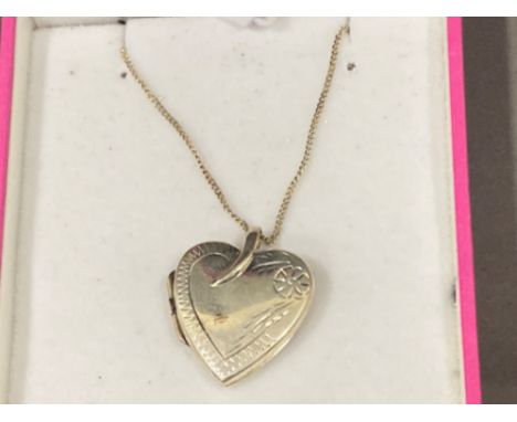 Silver heart shaped locket on chain