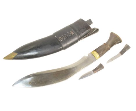 A vintage Nepalese / Gurkha Kukri knife dagger having a carved bone hilt, brass capped pommel and typical hooked blade. House