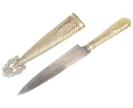 A vintage South American / Argentinian Gaucho / Cowboy knife with a matching scabbard and hilt with a floral tip. The blade s