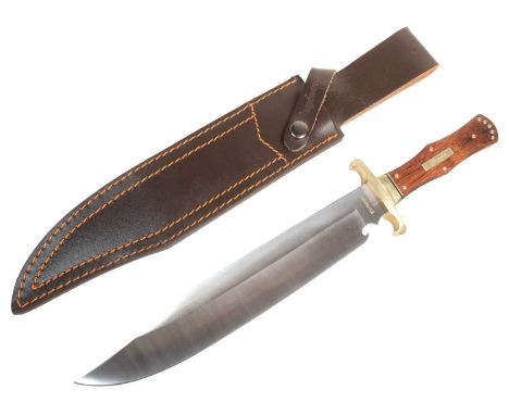 A vintage Wrangler made Bowie knife with coffin hilt wooden grip, full tang and brass guard. Stainless steel blade housed in 