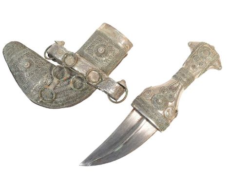 An early 20th Century small Arabian / Omani Khanjar / Jambiya dagger. The curved blade with a pronounced central rib housed i