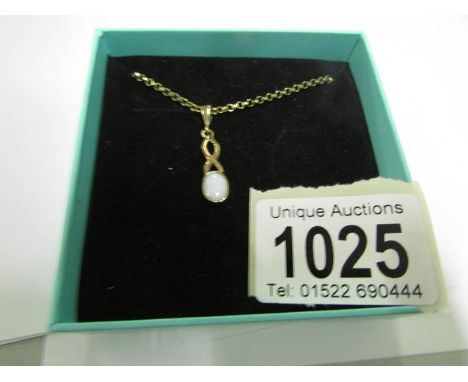 A 9ct gold opal pendant on a 9ct gold chain