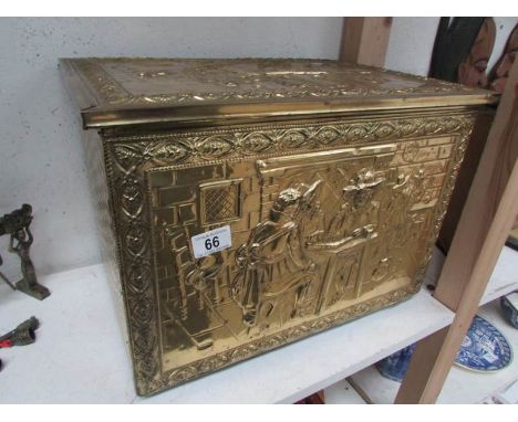 A brass coal box depicting men playing cards/chess