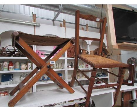 A cane seated chair and a folding stool