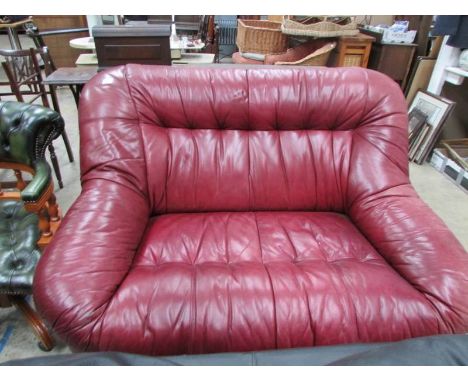 A tan leather 2 seat sofa