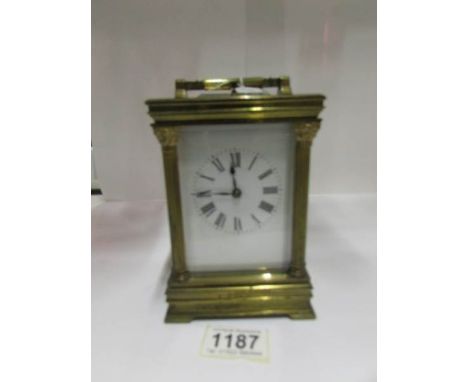 A good quality brass carriage clock with Corinthian style side pillars