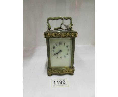 An ornate French brass carriage clock