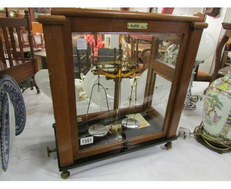 A cased set of Oertling balance scales with service history, in working order