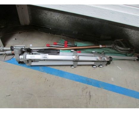 A tripod, shooting stick and surveyors stand