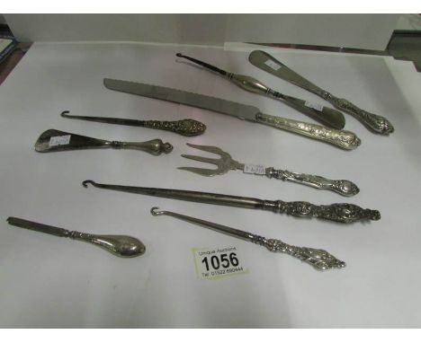 9 silver handled items including button hooks and shoe horns