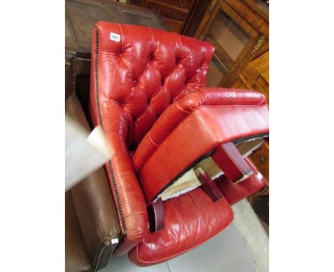 A red leather chair and stool