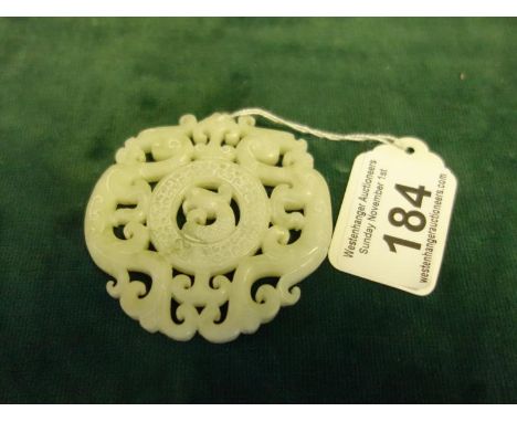 Celadon carved Jade item, circular, the centre section with a Fish, pierced carved decoration throughout, 2.3/4" dia,