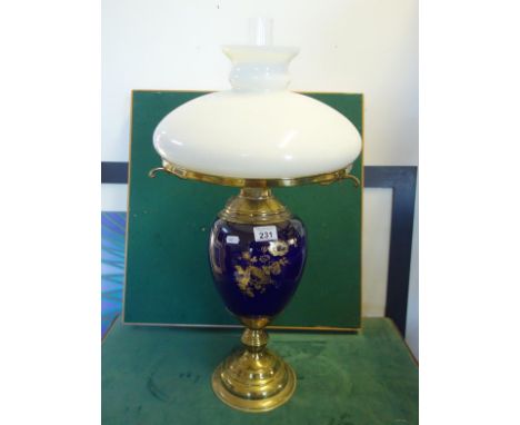 Decorative modern oil lamp in the antique style, glass shade and funnel above a centre china bowl on brass base, 24" tall