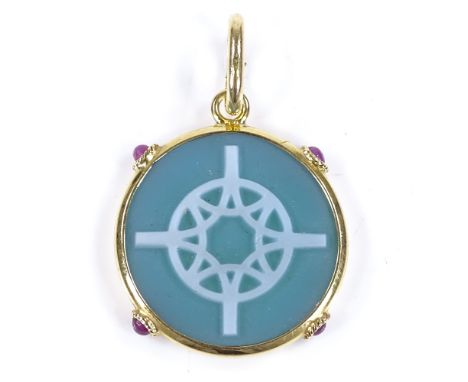 A circular relief carved green agate pendant, with cabochon ruby set 18ct gold frame, pendant diameter 22.1mm, 3.9g 